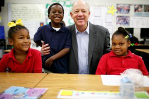 billy shore with school students in communities in need