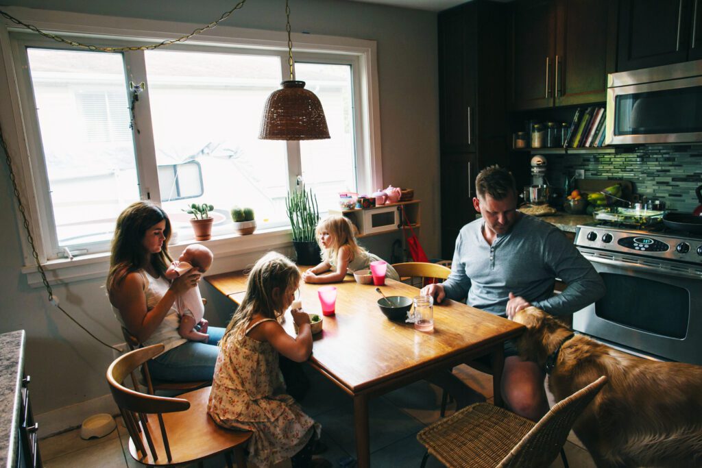 mom and dad and three small kids at the breakfast table
