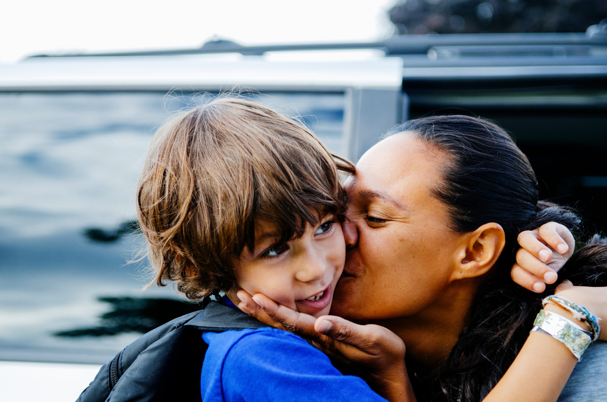 thank you woman kissing child on cheek