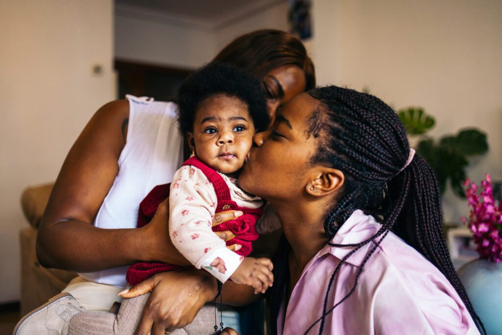 African American mom kissing her baby